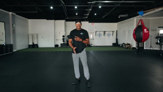 A Parkinson’s 101 coach mid-demonstration on the gym floor